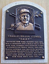 A metal plaque with Stengel's face and achievements