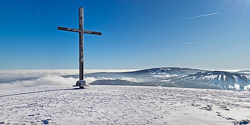 Summit cross on the Himmeldunkberg. In the background on the right the Kreuzberg