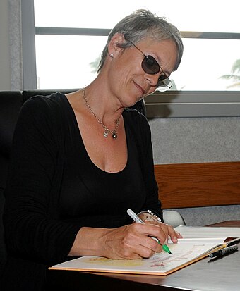 Curtis autographing a copy of her children's book in 2010