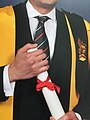KCL academic dress with AKC award shown as epitogue buttoned to the shoulder
