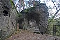 Poškozené reliéfy postav před jeskyní Klácelka