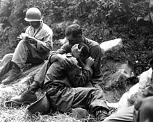 G.I. comforting a grieving infantryman KoreanWarFallenSoldier1.jpg
