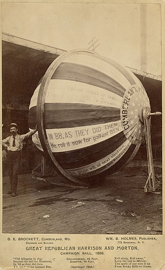 Man leaning on Harrison and Morton campaign ball.