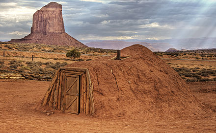Traditional male Navajo hogan. In many traditional Navajo hogans, the entrance faces the east so the sun shines into the hogan at sunrise and the hogan gets the early morning light.