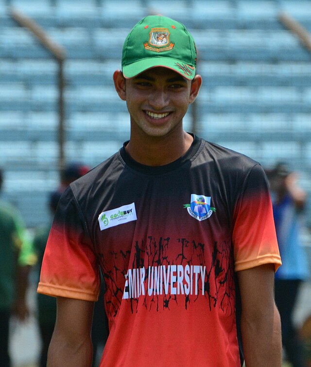 A man, wearing a cap (face only) is smiling