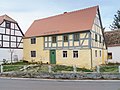 House, side building, barn and well of a farm