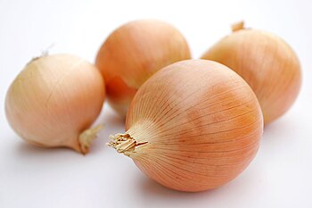 Onions on a neutral, mostly white background