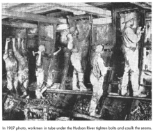 Workers in the North River Tubes tighten bolts and caulk seams in 1907 PCPOST HudsonRiverTubes 1907.png