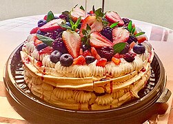 showy dessert with cream between the layers and fresh fruit on top