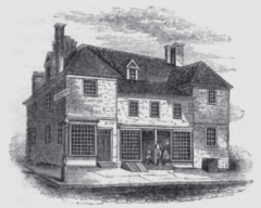 An 1850 sketch showing an addition between the two wings being used as a storefront. The artist noted the building's dilapidated state and correctly guessed it would be razed. Penns Slate Roof House Philadelphia Lossing.png