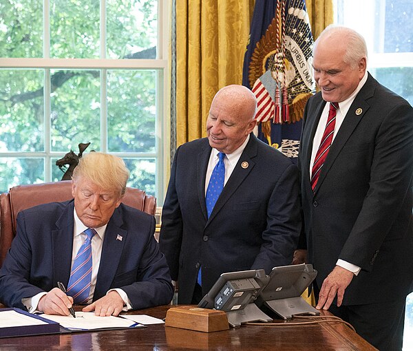 Kelly with President Trump as he signs the Taxpayer First Act into law