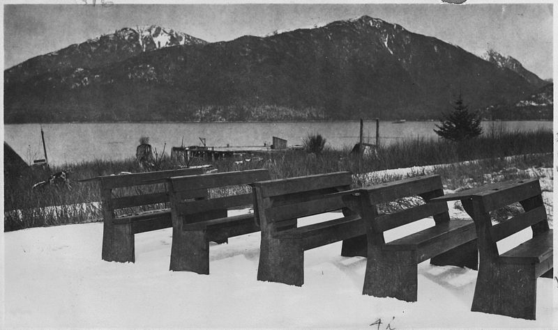 File:Row of school desks outside in snow, view of mountains and bay in background. - NARA - 297407.jpg