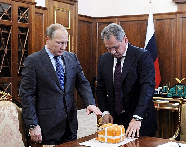 Russian Defence Minister Sergey Shoygu presents President Putin with the flight data recorder of the Su-24