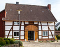 a) Half-timbered building of former body breeding b) Fountain from the 17th century