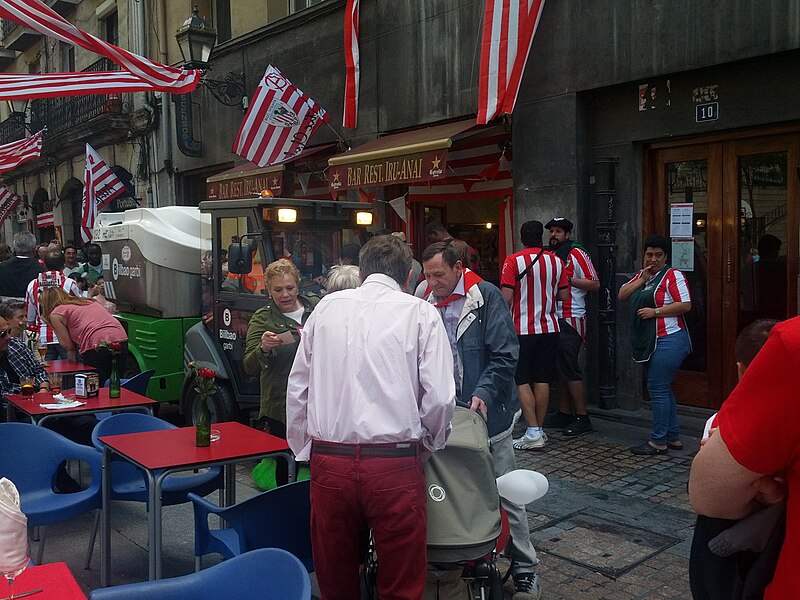 File:Street cleaning truck pushes through the crowd listening to the band (18823013785).jpg