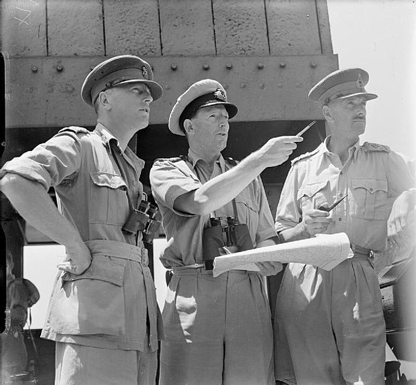 Left to right: Brigadier R. H. Senior, Captain P. S. Smith and Major General S. C. Kirkman on the bridge and watching the early stages of the invasion