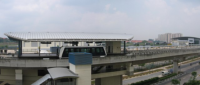 Tongkang LRT station is in the centre, with Sengkang Depot behind it. In the distant background lies the HDB blocks of the Fernvale neighbourhood.
