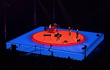 The turntable stage featured algorithmically-generated colourscapes during the semi-acoustic segment of the show. U2 performing at Sphere in Las Vegas on Dec 9 2023 by Frank Weigel (37) (cropped).jpg