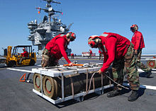 A crate used to transport ordnance US Navy 030830-N-6187M-001 Sailors remove a hoisting sling from an ammo crate carrying 2000-pound Mark 84 general purpose bombs.jpg