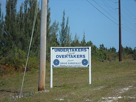 ไฟล์:Undertakers Love Overtakers Please Drive Carefully Rotary Club Freeport Road Sign Grand Bahamas.jpg