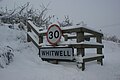 The village sign at Ventnor Road for Whitwell, Isle of Wight, seen shortly after heavy snowfall on the island during the night.