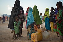 Women and children line up outside a water distribution area in an IDP camp in Hiran, Somalia, in 2016. The implications of the Kampala treaty for women and special populations have recently been emphasized in scholarly and international organization analyses of the Convention. 2016 28 Beletweyne IDP Camp-15 (27319751715).jpg