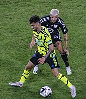 Tolkin (in black) playing in the 2023 MLS All-Star Game in July 2023 2023 MLS All Star Game 2023-07-19 Fabio Vieira John Tolkin.jpg