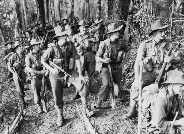 Troops of the 2/16th Infantry Battalion watch aircraft bombing Japanese positions prior to their attack on "The Pimple", Shaggy Ridge, New Guinea.