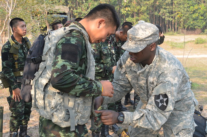 File:A member of the Royal Thai Army gets help with an American standard-issue Improved Outer Tactical Vest from U.S. Army Pfc. James Phillips, right, during exercise Cobra Gold 13 at an unknown location in Thailand 130212-A-LK473-001.jpg