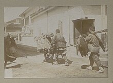 A wheelbarrow puller in Shanghai. A wheelbarrow puller in Shanghai, 1897 (Louis-Jules Dumoulin).jpg