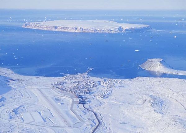 Aerial view of Pituffik Space Base with Saunders Island in the background and the tombolo on the right