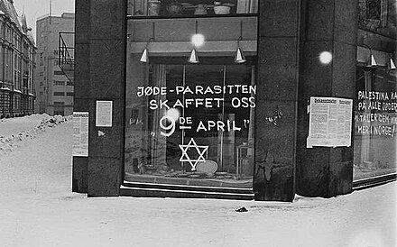 Anti-Semite graffiti on shop windows in Oslo in 1941. (The location is at the junction of present-day Henrik Ibsen's Street and Crown Prince Street.) The address is called "Glitne-gården" by some.[1]