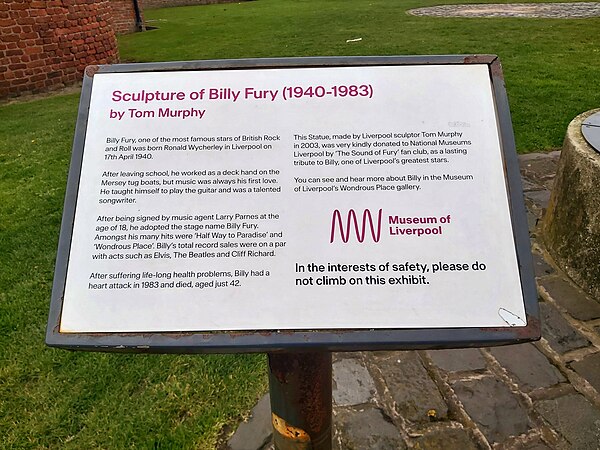 The statue's plaque, featuring a small biography about Fury's life