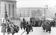 German policemen lay a wreath on the monument to Captains Anlauf and Lenck during the Day of the German Police, 16 January 1937. Despite the fact that Captains Anlauf and Lenck were members of the SPD, the Nazi salute is given by many of those present. In 1951, Mielke ordered the demolition of the monument. Bundesarchiv Bild 183-C00678, Berlin, Rosa-Luxemburg-Platz, Kranzniederlegung.jpg