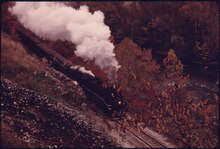 A Cuyahoga Valley Excursion led by Grand Trunk Western 4070 traveling along the Cuyahoga River near Akron, in October 1975 CUYAHOGA VALLEY LINE STEAM POWERED WEEKEND EXCURSION TRAIN MOVES ALONG THE CUYAHOGA RIVER BELOW RIVERVIEW ROAD NEAR... - NARA - 557967.tif