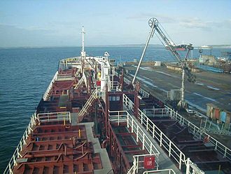 A chemical or oil tanker connected to the pier with a marine loading arm. Chassiron main deck.jpg