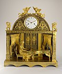 Clock; 1807-1810; fire-gilt bronze, blackened bronze, enameled metal (dial), blued steel (hands); glass; 56 x 49.7 x 18.5 cm; Cooper Hewitt, Smithsonian Design Museum (New York City)