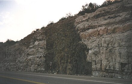 A diabase dike crosscutting horizontal limestone beds in Arizona