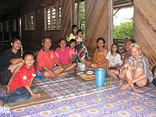 An Iban family serving guest tuak. Dinner with Iban family (8035179786).jpg