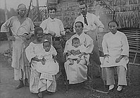 A Native Filipina with Caucasians (probably Europeans or Americans), Chinese, and Japanese settlers in the Philippines, c. 1900