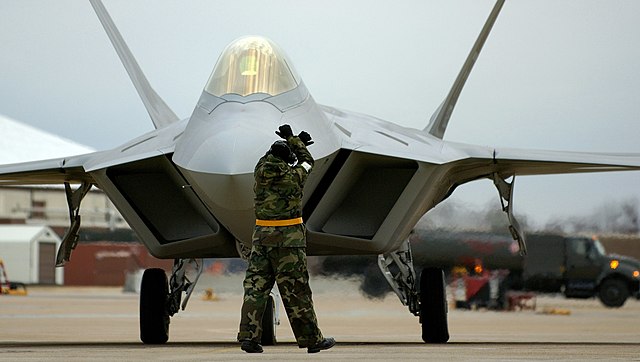 F-22A from the 1st Fighter Wing, 27th Fighter Squadron, Langley AFB, Virginia being marshalled into place on the flightline