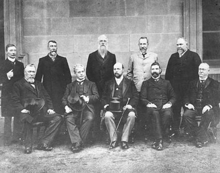 Edmund Barton is seated second from the left, surrounded by the Federal Executive Council, comprising his Cabinet ministers and the Governor-General, 