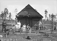 Louisiana Choctaws in front of their cabin in 1909 Group of Nine Near Wood Frame Building 1909.jpg