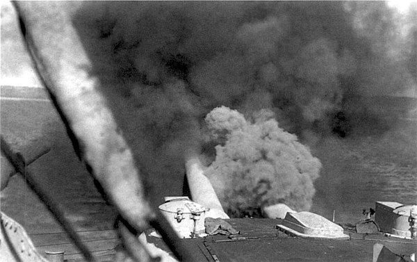 HMS Canopus fires a salvo from her 12 in (305 mm) guns against Ottoman forts in the Dardanelles.