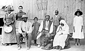 Harriet Tubman with family and ex-slaves; sitting at left is Tubman's second husband, Nelson Davis (8th USCT veteran) Harriet Tubman, with rescued slaves, New York Times.JPG