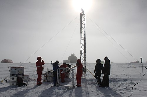 Ice Core Researchers in Greenland by Helle Astrid Kjær. Ice core researchers drilling at the East Greenland Ice-Core Project site.