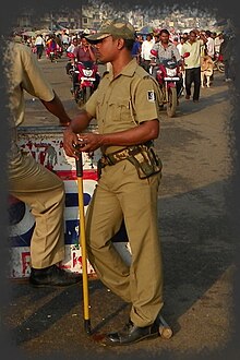 lathi equipped police constable at Jagannath Temple, Puri, Odisha. Jaganath Temple 12 - police (26516578071).jpg