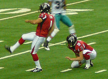 Koenen (right) holding for placekicker Jason Elam with the Falcons in 2009. Jason Elam Michael Koenen.jpg