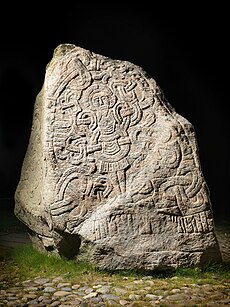 Large stone containing a carved depiction of Jesus Christ
