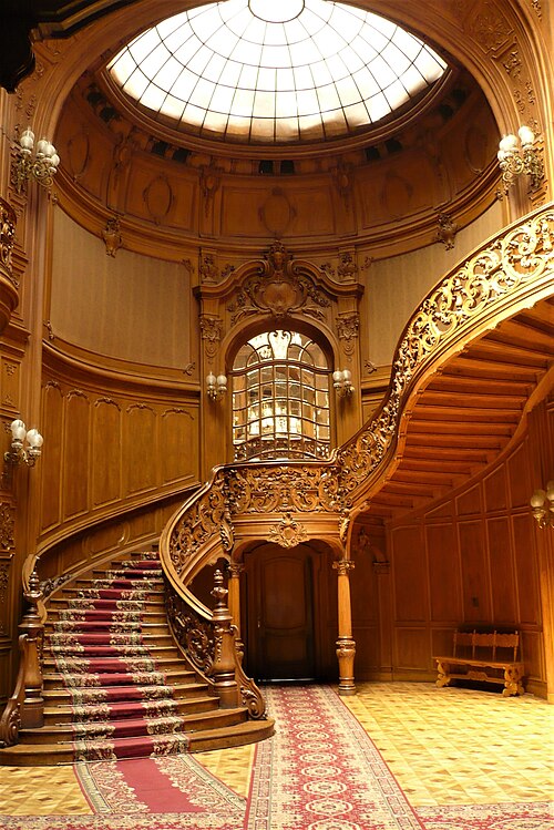 Neo-Baroque stairs with intricate wooden balustrade